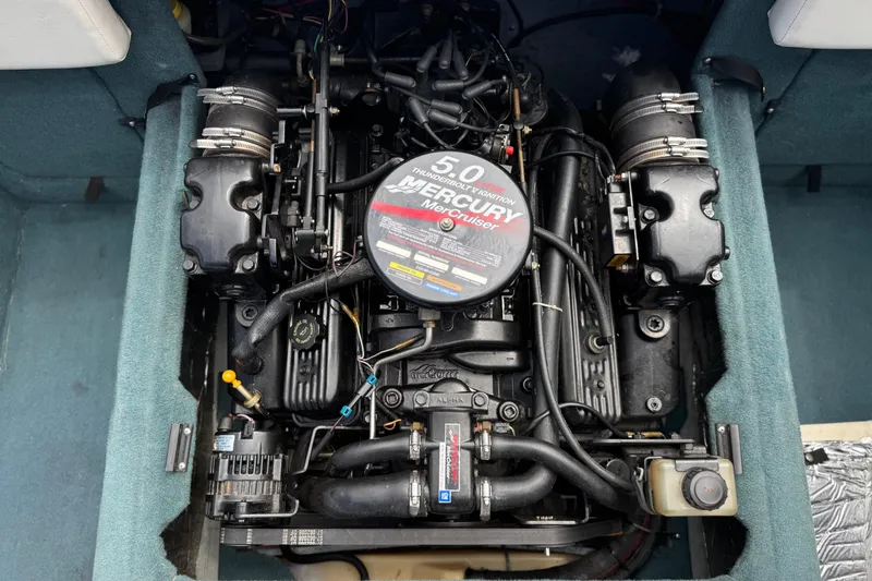 Slide: The Image of Engine of a 2000 Bayliner 2150 Capri boat, featuring a 5.0 Mercury MerCruiser. - 14