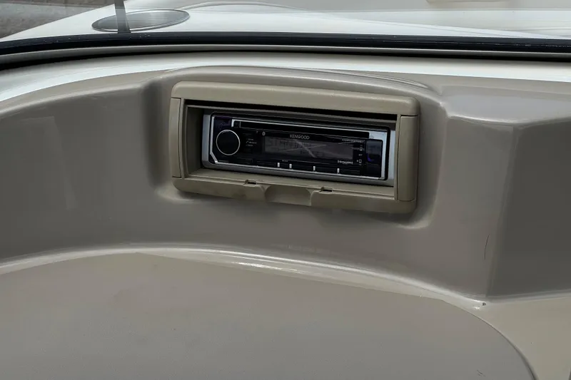 Slide: The Image of Dashboard of a 2000 Bayliner 2150 Capri featuring a Kenwood stereo system. - 16