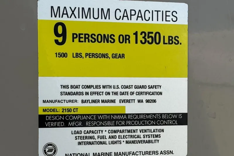 Slide: The Image of Bayliner 2150 Capri 2000 capacity label: 9 persons or 1350 lbs, U.S. Coast Guard compliant. - 25