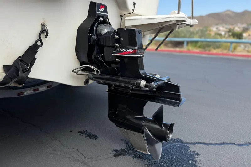 Slide: The Image of Bayliner 2150 Capri 2000 boat with Mercury outboard motor on a trailer. - 6