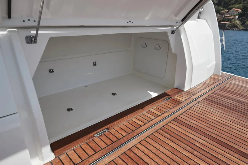 Slide: The Image of Prestige 420 Yacht 2021 with open storage compartment on wooden deck. - 14