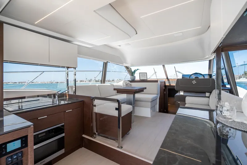 Slide: The Image of Interior of a 2021 Prestige 420 yacht with modern kitchen and seating area. - 9