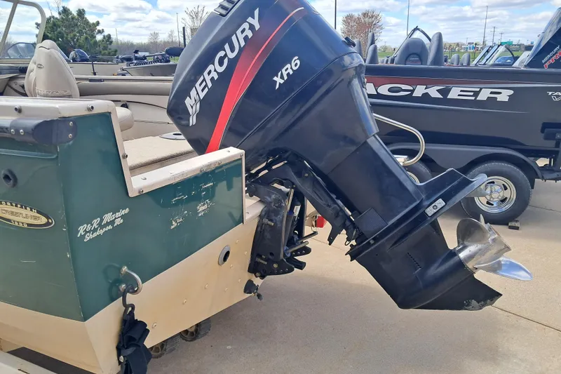Slide: The Image of 2002 Crestliner 1850 Sportfish boat with Mercury XR6 outboard motor, parked outdoors. - 3