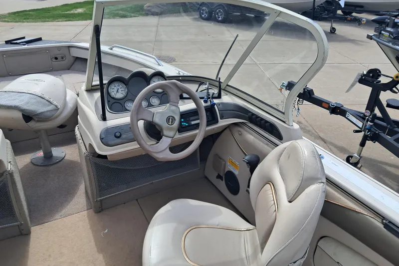 Slide: The Image of 2002 Crestliner 1850 Sportfish boat interior with steering wheel and dashboard controls. - 5