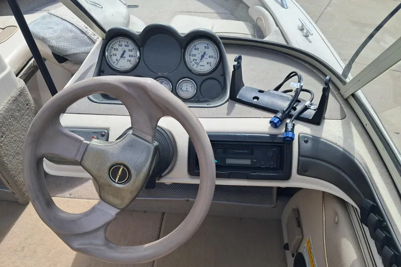 Slide: The Image of 2002 Crestliner 1850 Sportfish dashboard with steering wheel and gauges. - 6