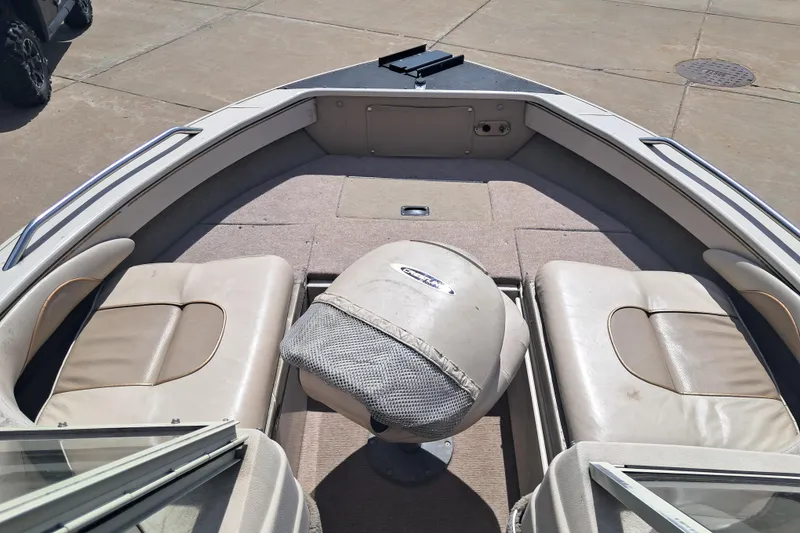 Slide: The Image of 2002 Crestliner 1850 Sportfish boat interior with seating and carpeted deck. - 7