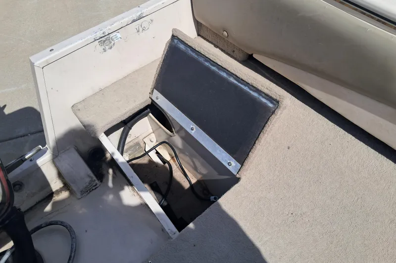 Slide: The Image of Open storage compartment on 2002 Crestliner 1850 Sportfish boat deck. - 9