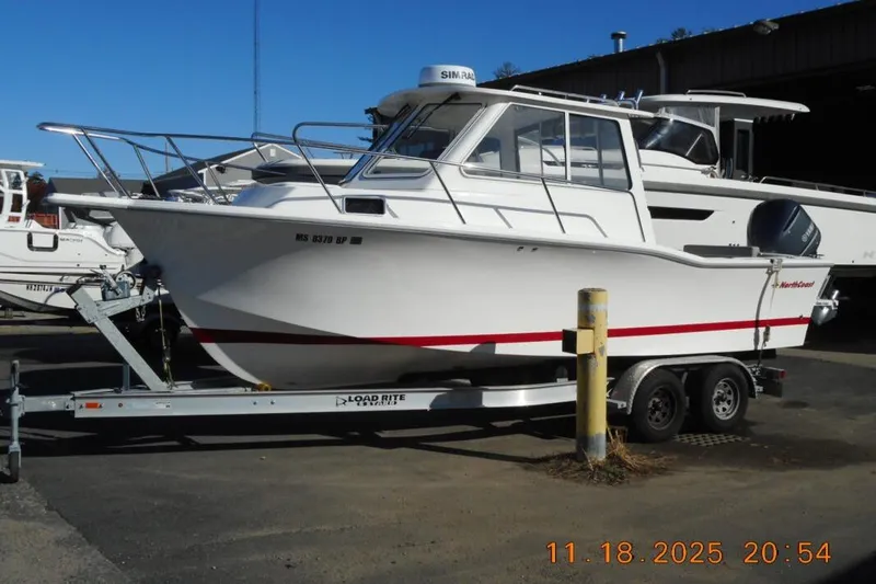 The Image of 2021 NorthCoast 235 HT boat on trailer in a marina setting. - 0