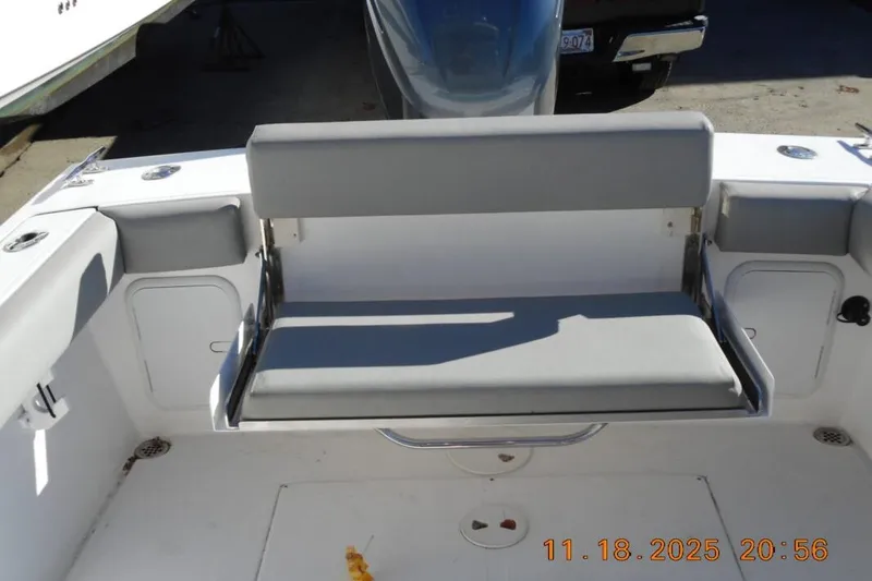 Slide: The Image of 2021 NorthCoast 235 HT boat interior with foldable bench seat and storage compartments. - 3