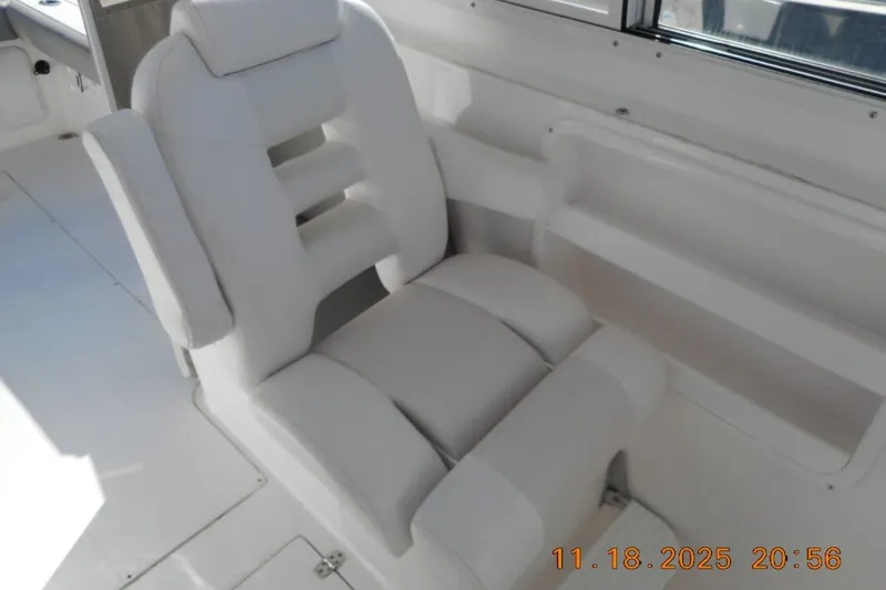 Slide: The Image of White captain's chair on 2021 NorthCoast 235 HT boat interior. - 5
