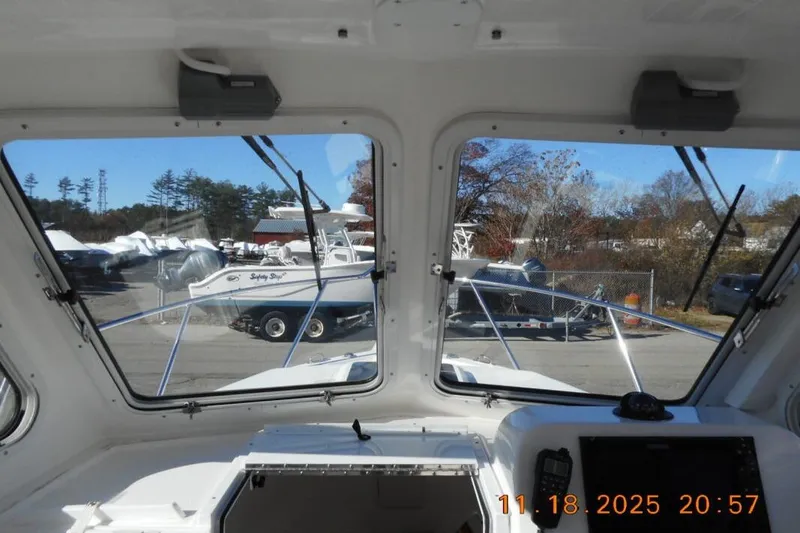 Slide: The Image of Interior view from a 2021 NorthCoast 235 HT boat, showcasing the windshield and dashboard. - 8