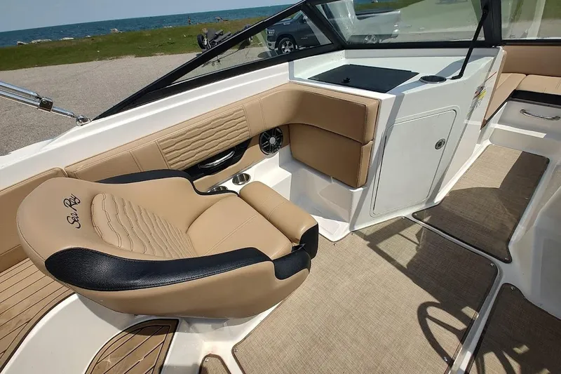 Slide: The Image of Luxurious interior of 2023 Sea Ray SPX 190 boat with tan and black seating. - 13