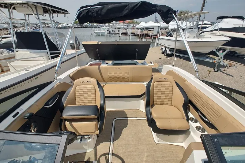Slide: The Image of Interior view of 2023 Sea Ray SPX 190 boat with tan seating and modern design. - 15