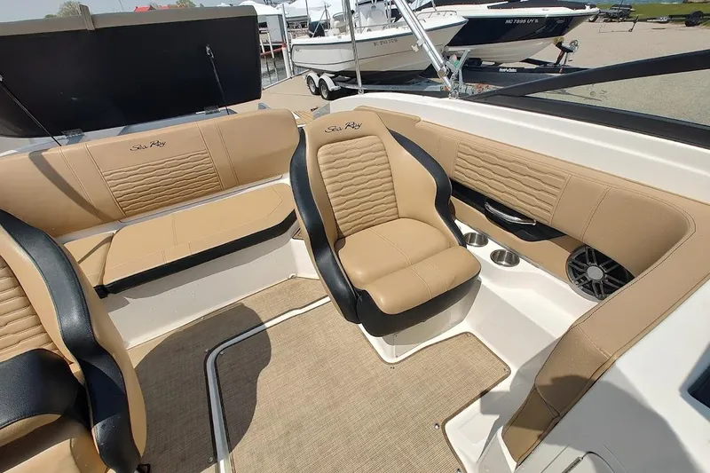 Slide: The Image of 2023 Sea Ray SPX 190 boat interior with tan leather seating and cup holders. - 17