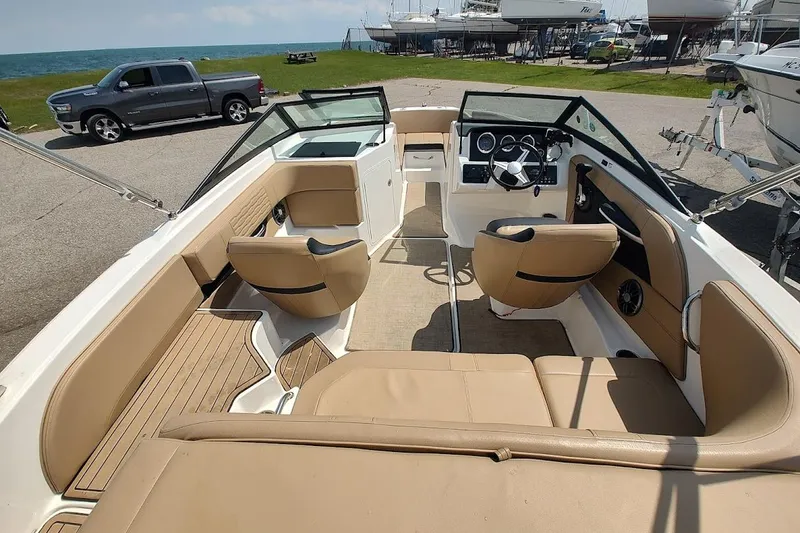 Slide: The Image of 2023 Sea Ray SPX 190 boat interior with tan seating and modern dashboard. - 22