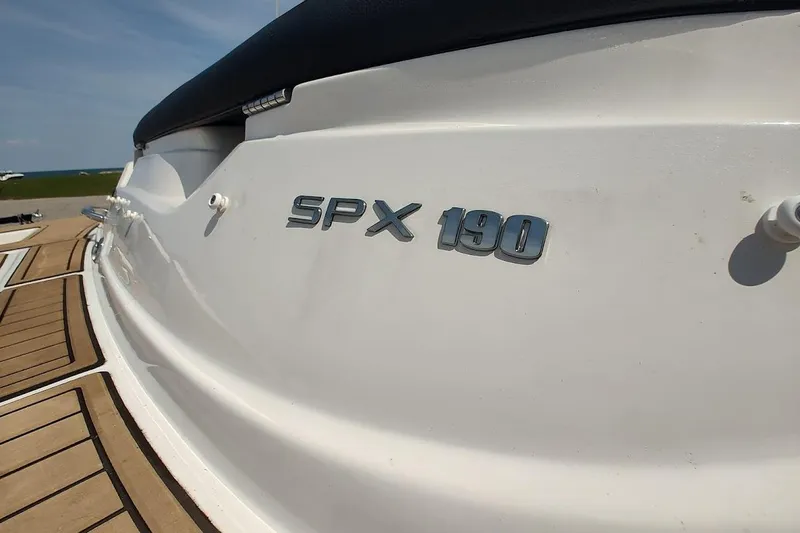 Slide: The Image of 2023 Sea Ray SPX 190 boat, close-up of model name on white hull. - 23
