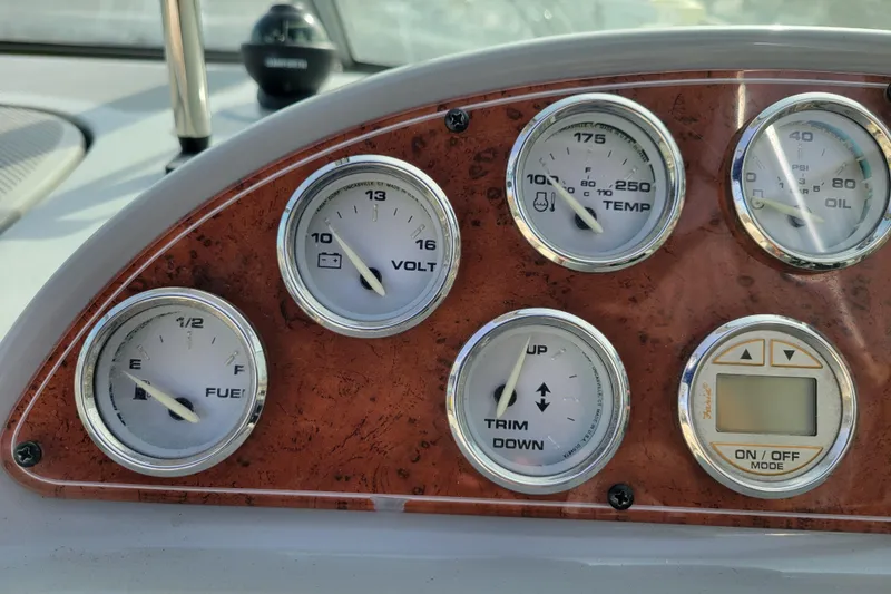 Slide: The Image of Dashboard gauges of a 2007 Bayliner 245 Cruiser boat, showing fuel, voltage, temperature, and oil levels. - 16