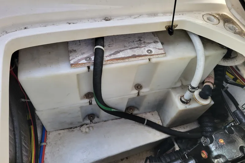 Slide: The Image of 2007 Bayliner 245 Cruiser engine compartment with hoses and wiring visible. - 20