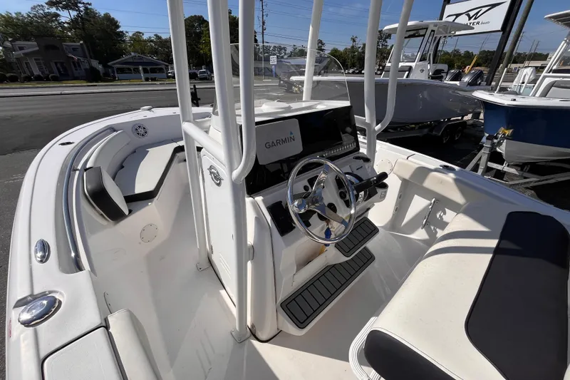 Slide: The Image of 2022 Tidewater 210 LXF boat interior with Garmin navigation system and seating. - 13