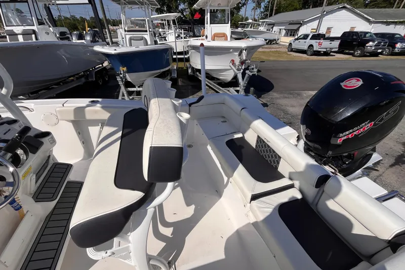 Slide: The Image of 2022 Tidewater 210 LXF boat interior with seating and powerful outboard motor. - 14