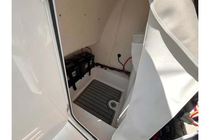 Slide: The Image of Interior view of 2022 Tidewater 210 LXF boat compartment with batteries and wiring. - 16