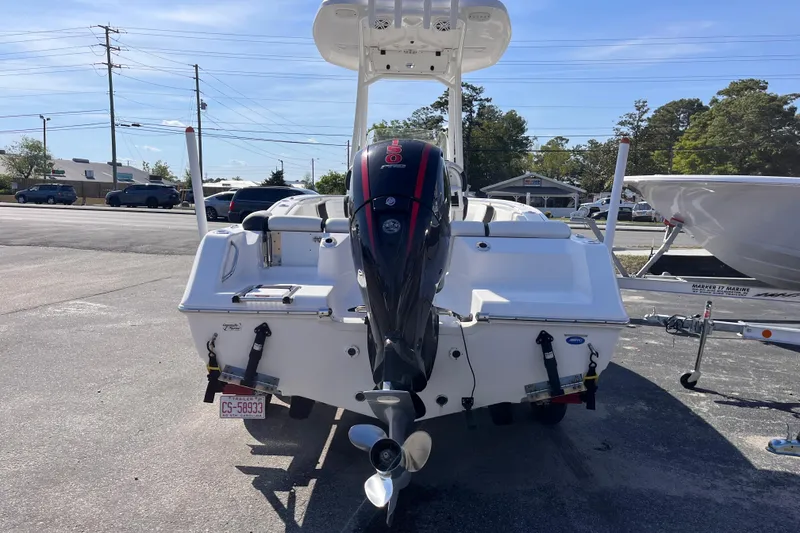 Slide: The Image of 2022 Tidewater 210 LXF boat with outboard motor, parked on a sunny day. - 3