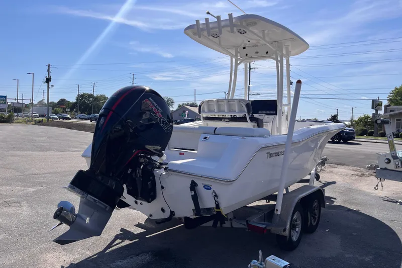 Slide: The Image of 2022 Tidewater 210 LXF boat on trailer with powerful outboard motor in sunny parking lot. - 4