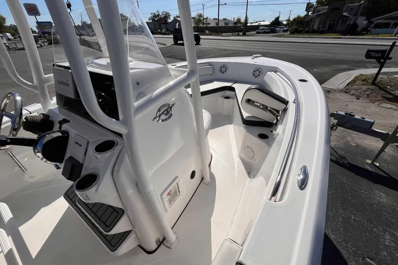 Slide: The Image of 2022 Tidewater 210 LXF boat interior with steering console and seating area. - 8