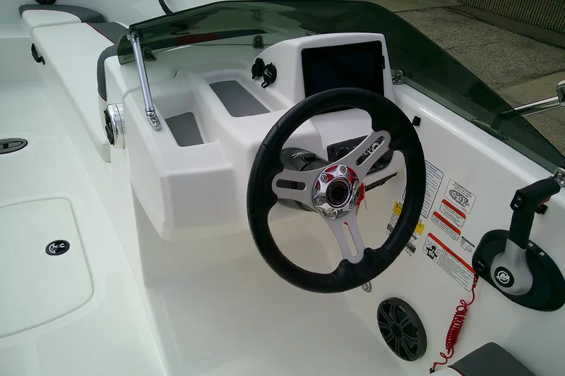 Slide: The Image of 2024 Tahoe T18 boat dashboard with steering wheel and control panel. - 12