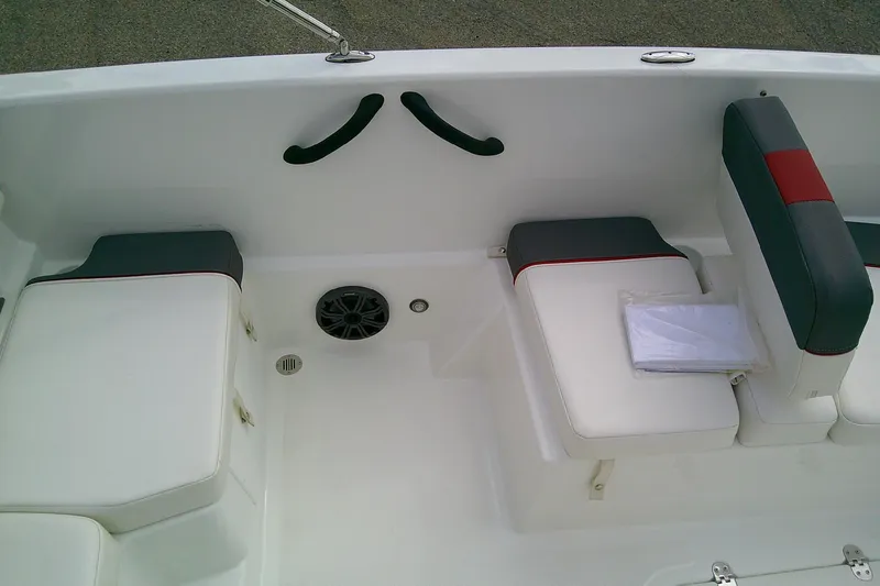 Slide: The Image of 2024 Tahoe T18 boat interior with white and gray seating, featuring red accents. - 13