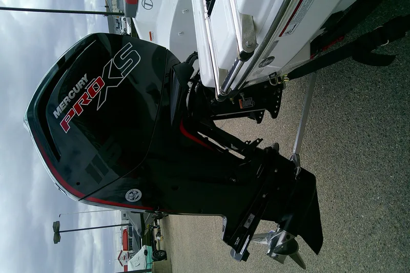 Slide: The Image of 2024 Tahoe T18 boat with Mercury Pro XS outboard motor, parked on pavement. - 14