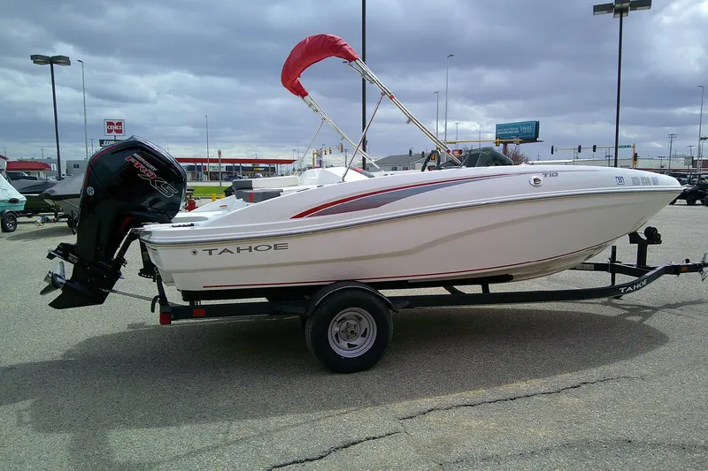 Slide: The Image of 2024 Tahoe T18 boat on trailer in parking lot, overcast sky. - 3