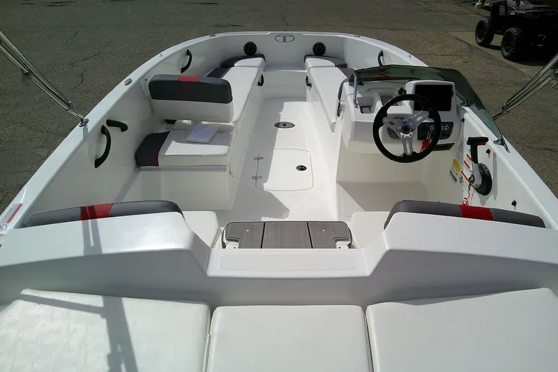 Slide: The Image of 2024 Tahoe T18 boat interior with modern seating and steering console. - 6