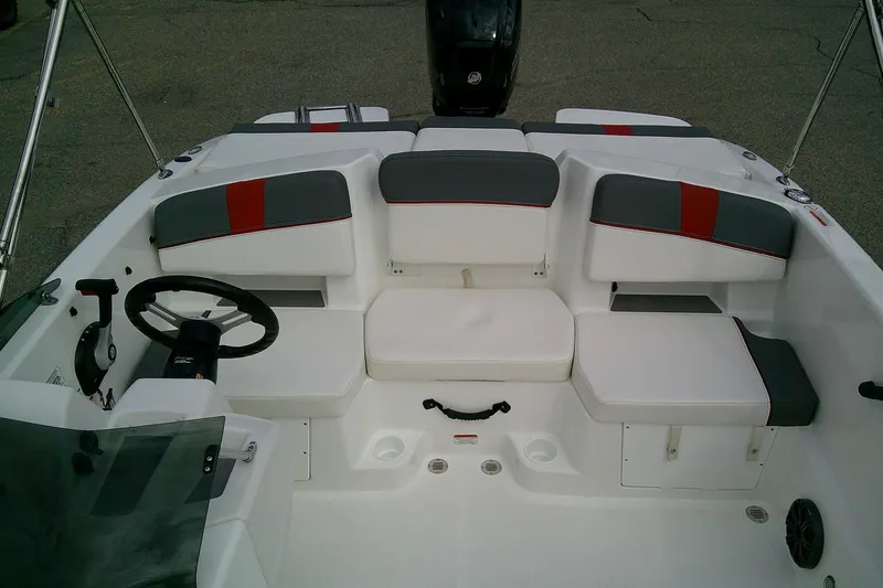 Slide: The Image of 2024 Tahoe T18 boat interior with white and gray seating, steering wheel, and controls. - 9