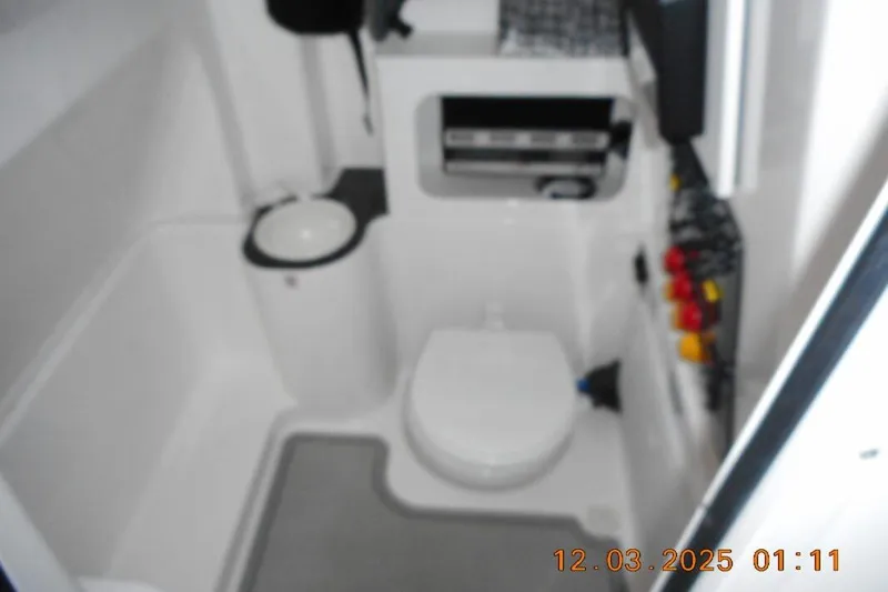 Slide: The Image of Interior of 2023 Sea Fox 288 Commander boat bathroom with toilet and storage. - 13