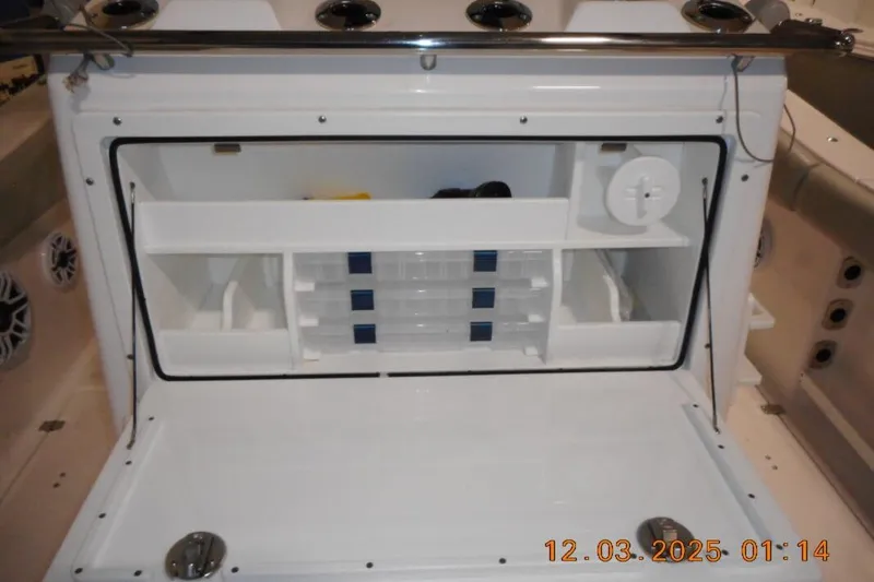 Slide: The Image of 2023 Sea Fox 288 Commander boat storage compartment with organized shelves and tackle boxes. - 17
