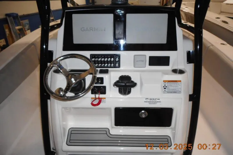Slide: The Image of 2023 Sea Fox 288 Commander boat dashboard with Garmin display and steering wheel. - 4