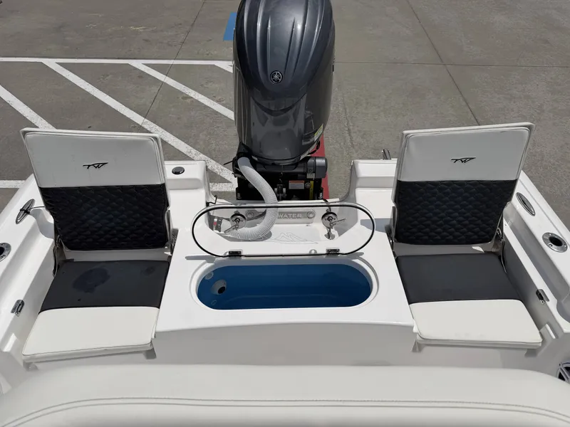 Slide: The Image of Rear view of 2026 Tidewater 2110BMT boat with engine and seating. - 11