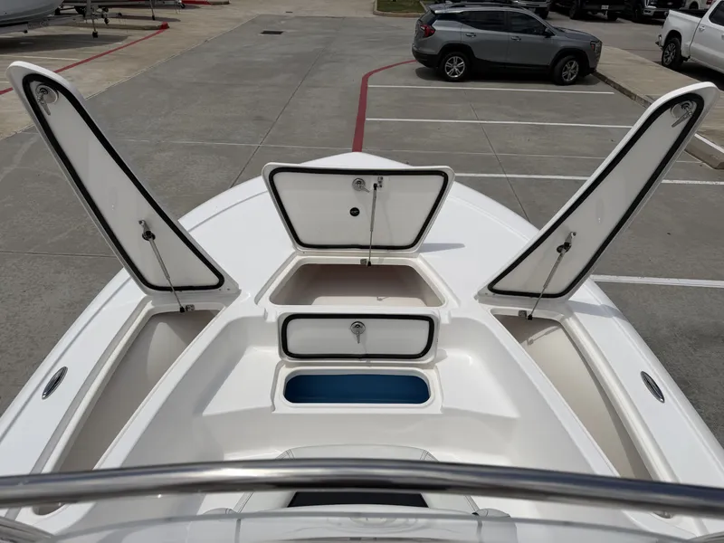 Slide: The Image of Tidewater 2110BMT 2026 boat with open storage compartments at dock. - 33
