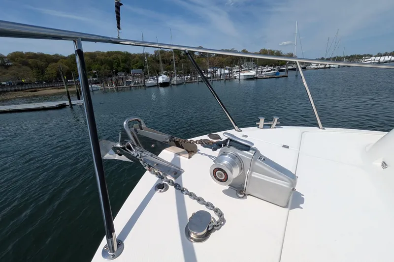 Slide: The Image of Bow of 2005 American Tug 41 with anchor and winch, docked in a marina. - 12