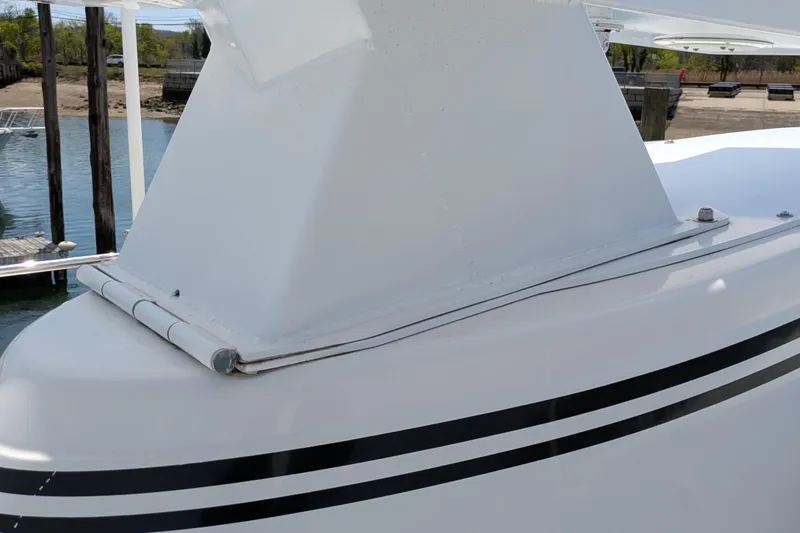 Slide: The Image of Close-up of 2005 American Tug 41 boat deck with sleek white design and black stripes. - 18