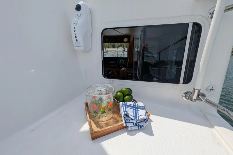 Slide: The Image of Outdoor view on 2005 American Tug 41 with limes, pitcher, and towels on deck. - 22