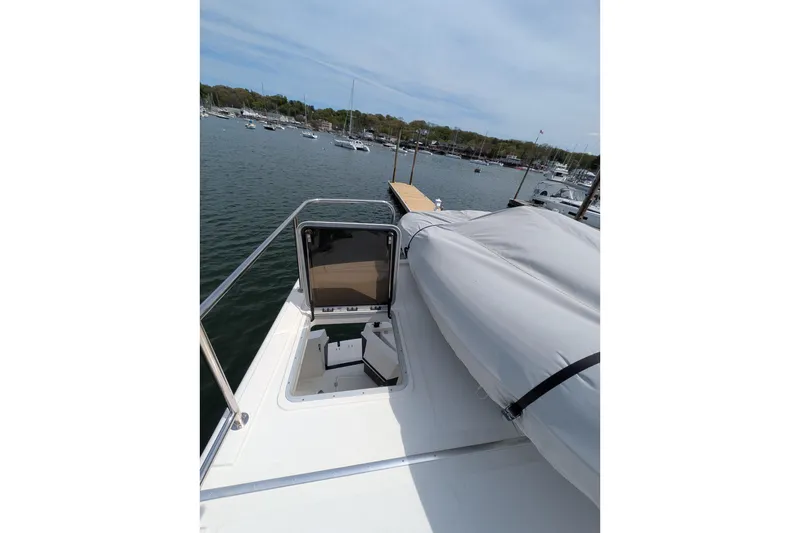 Slide: The Image of American Tug 41 (2005) boat deck with hatch, docked in a marina. - 23