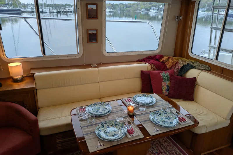 Slide: The Image of Cozy dining area in a 2005 American Tug 41 with elegant table setting. - 31