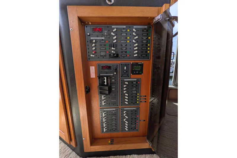 Slide: The Image of Electrical panel of a 2005 American Tug 41 boat, featuring switches and meters. - 36