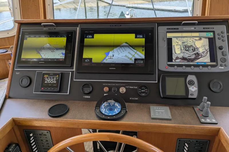 Slide: The Image of Navigation dashboard of a 2005 American Tug 41 with multiple electronic displays. - 38