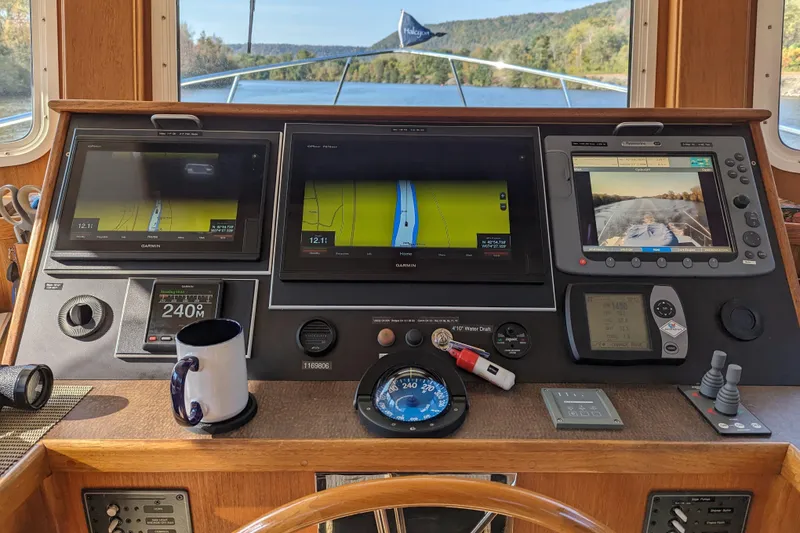 Slide: The Image of American Tug 41 (2005) helm with navigation screens and controls. - 39