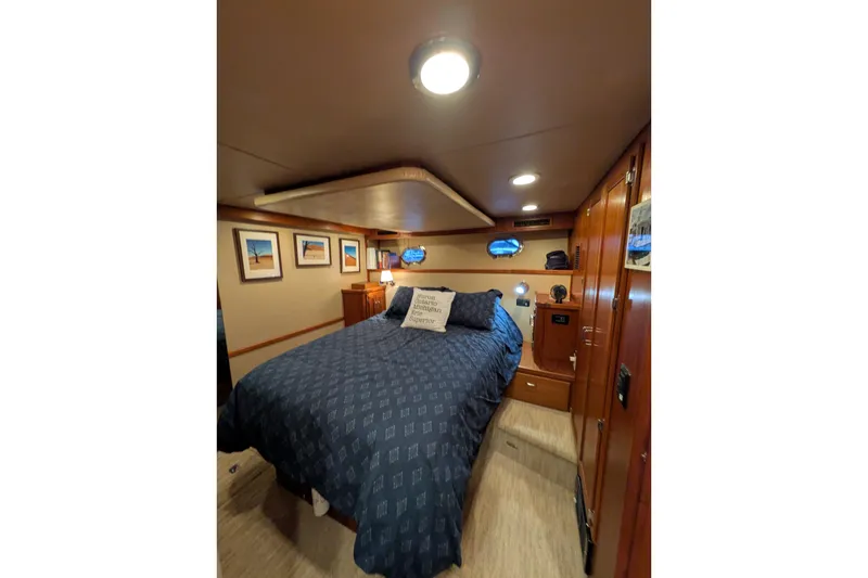 Slide: The Image of Cozy cabin interior of 2005 American Tug 41 with nautical decor and comfortable bedding. - 4