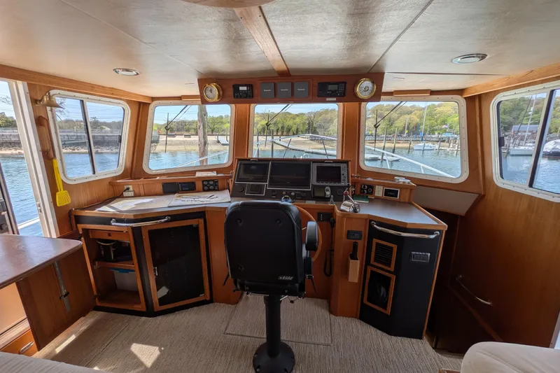 Slide: The Image of Pilothouse of 2005 American Tug 41 with navigation equipment and panoramic windows. - 41
