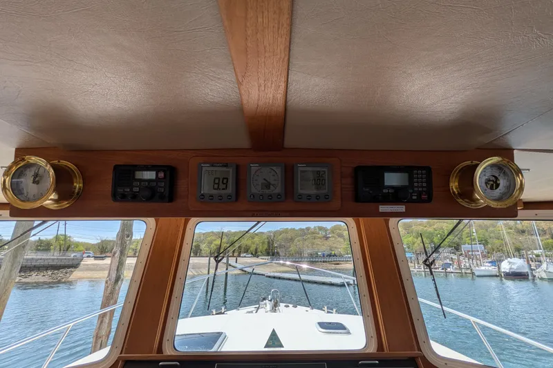 Slide: The Image of Pilothouse dashboard of a 2005 American Tug 41 with navigation instruments and gauges. - 43